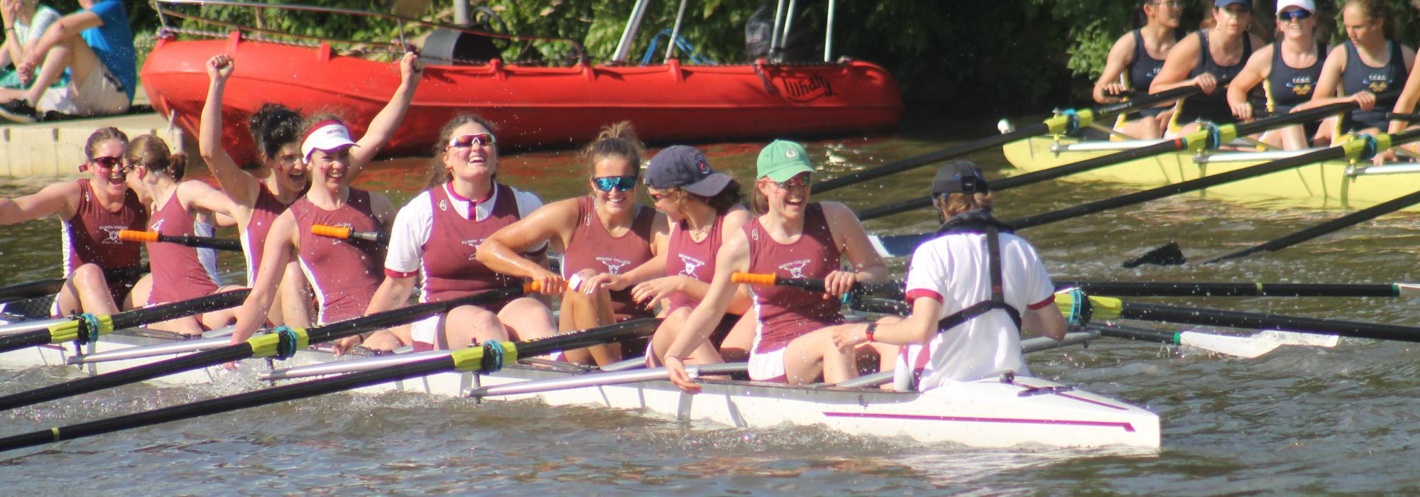 Merton W1 Celebrating success in the Summer Eights Women rowers in a boat celebrating